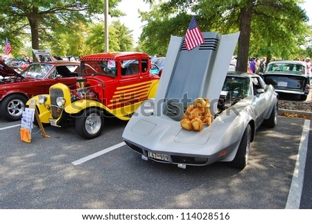 FREDERICK, MD- SEPTEMBER 16: 1962 Yellow Red Ford Coupe, and  1979 Silver Chevrolet Corvette on Sept. 16, 2012 in Frederick , MD USA. Alzheimer\'s Association Benefit Car Show at MVA in Maryland.