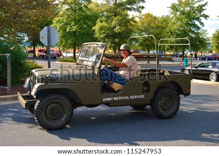 FREDERICK, MD- SEPTEMBER 16: Unidentified Man driving a 1965 U.S. Army Jeep Ambulance on Sept. 16, 2012 in Frederick , MD USA. Alzheimer\'s Association Benefit Car Show at MVA  in Maryland.