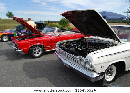 FREDERICK, MD- SEPTEMBER 16: 1960 White Chevrolet 2 Door Sedan ,and a Classic Red Convertible Car on Sept. 16, 2012 in Frederick , MD USA. Alzheimer\'s Association Benefit Car Show at MVA in Maryland.