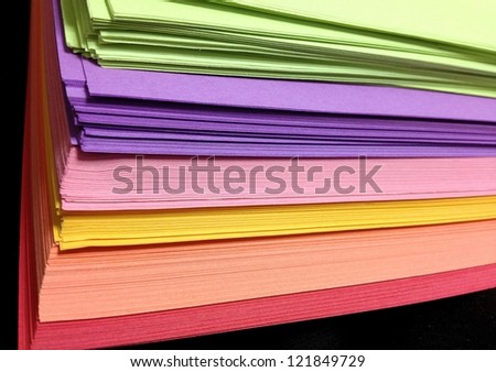 Assorted Colored Pile of Papers on Black Background