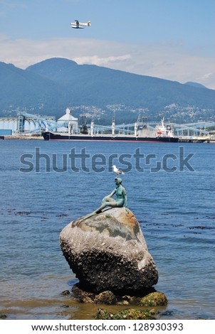 VANCOUVER - JULY 05:Girl in a Wet Suit Sculpture at  Stanley Park on July 05, 2008 in Vancouver Canada. Famous Mermaid Sculpture at Stanley Park shore in Vancouver.