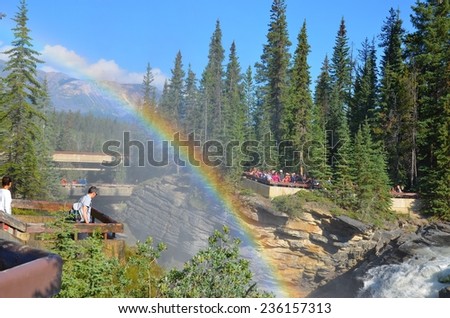 ATHABASCA FALLS, ALBERTA - AUGUST 1 - Rainbow at Athabasca waterfalls in Alberta, Canada on August 01, 2014. Thousands of people come every year to see the falls,