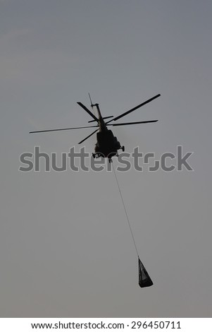 helicopter in the action, flying over the lake in the forrest