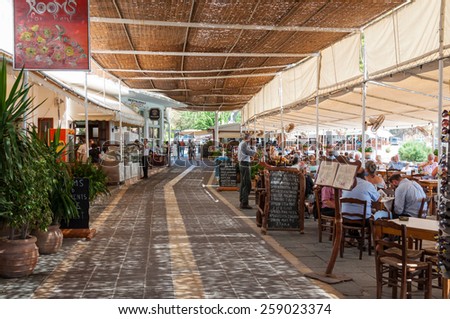HORA SFAKION, GREECE - SEPTEMBER 15. Tourists have lunch in taverns and restaurants in the shadow directly at the mediterranean on September 15, 2014 in Hora Sfakion on Crete.
