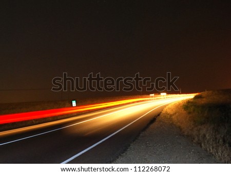 Highway at night with traces red and yellow of cars.