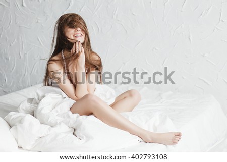 Laughing beautiful woman on the bed