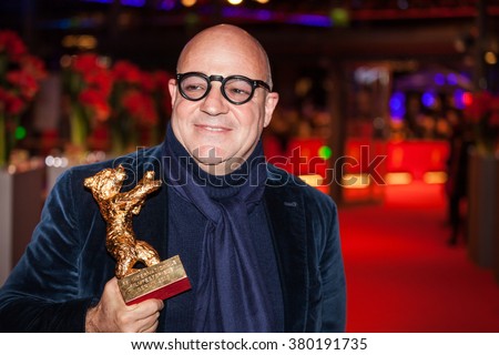 Berlin, Germany - February 20, 2016  - Director Gianfranco Rosi, winner of the Golden Bear for Best Film for his movie 'Fuocoammare', poses with his award after the closing ceremony of 66th Berlinale