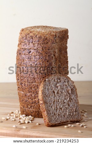 slice of whole wheat toast bread on a wooden board and seeds