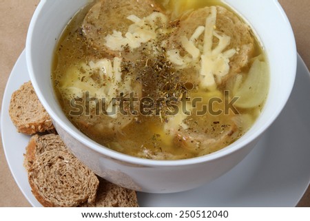french onion soup with a cheese in a white bowl