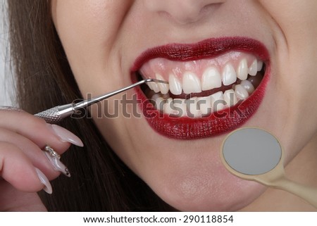 teeth and lips - dental tools - bright red lips with very white teeth beautiful young girl