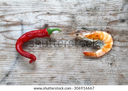 shrimp - prepared fresh seafood scampi on natural organic rustic wooden background - hot pepper - fresh red chili peppers in colors  on organic natural wooden rustic background