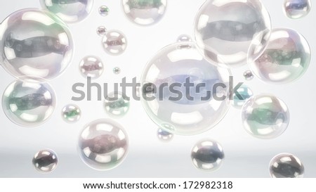 Floating reflective bubbles or glass spheres over a bright white cyc background