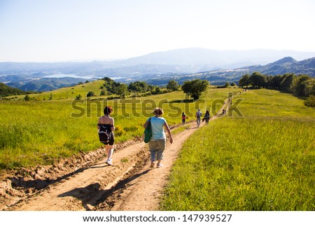 People walking in a green mountain path in Italian Apennines