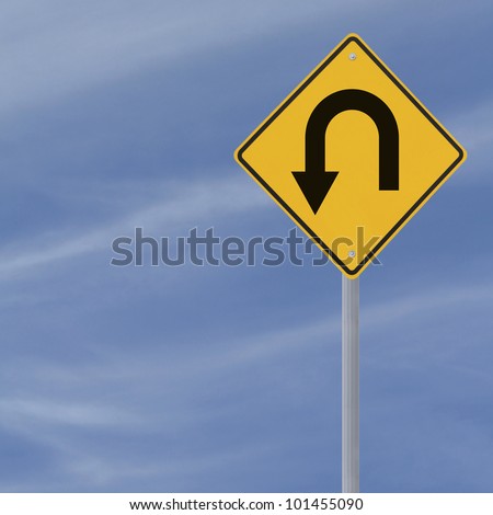 U-Turn road sign on a blue sky background with copy space