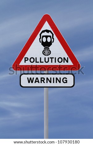 A road sign warning of pollution ahead (against a blue sky background)
