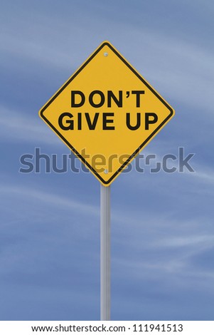 Don\'t Give Up road sign (against a blue sky background)