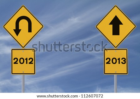 Conceptual road signs on the new year (against a blue sky background with copy space)