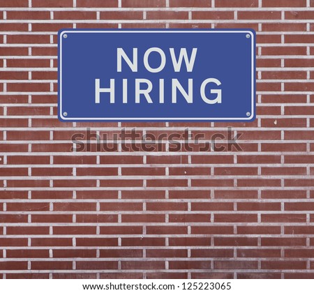 A job opportunity sign on a red brick wall