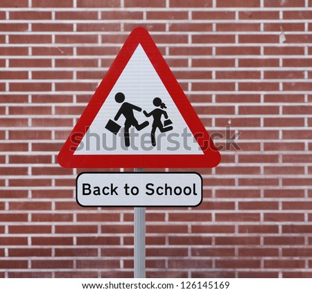 A Back To School road sign with a brick wall background