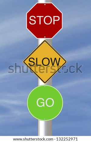 Stop Slow Go road signs against a blue sky background