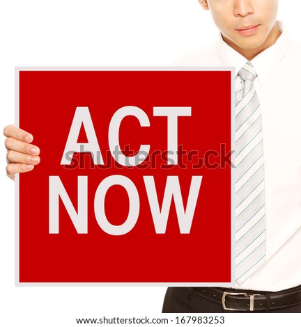 A businessman holding a sign indicating Act Now