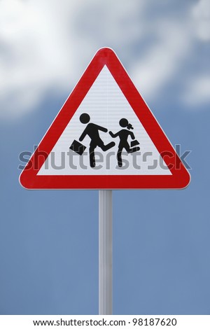School children crossing sign with a soft  sky background