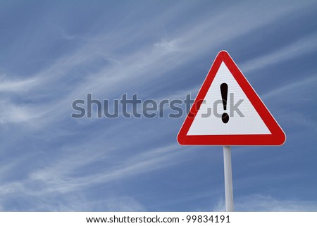 Warning sign with exclamation point with a blue sky background