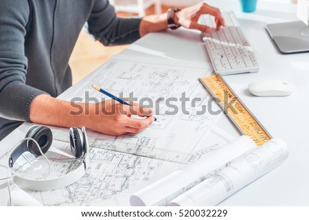 Hands of Engineer drawing on architectural project. Freelance work.\
Selective focus.