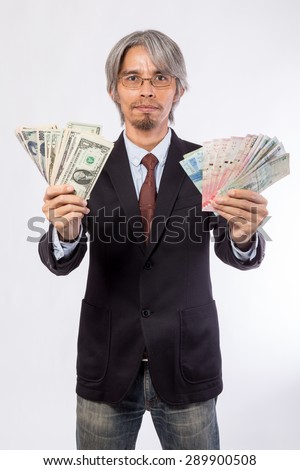 Happy business man hold China , hongkong , united state of america, korea and japan money over a white background, asian model 30s - 40s