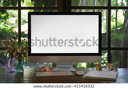 Boho style workplace. The monitor on a desk mockup scene over window. The working surface of the computer. Roses flowers, summertime, working at home concept.