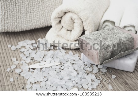 Spa setting with bath salt, soap and towel.