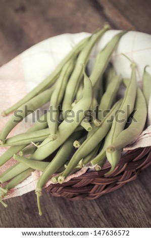 French bean on wooden table. photo in old style