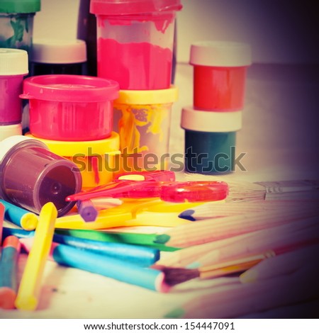 Creative Art Background made of old paint, colored pencils and other tools for drawing