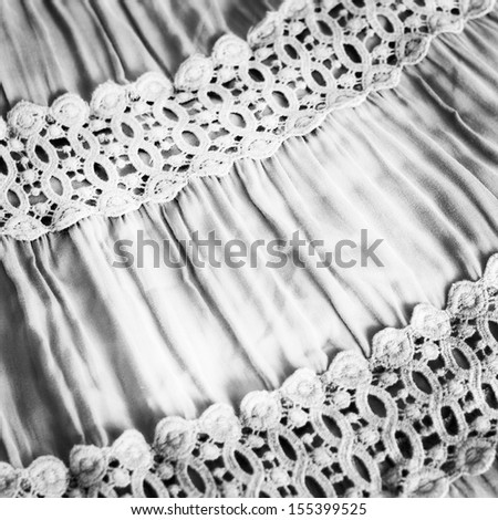 black & white photo. Fabric with the assembly and lace