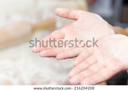 child hands cuts dough. children\'s hands in flour