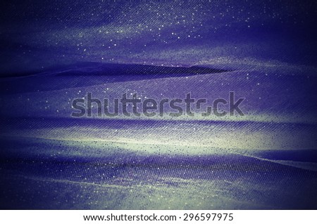 Abstract background from dark blue delicate fabric
