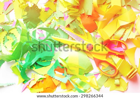 pieces of colored paper and scissors. Pieces of colored paper that sliced child
