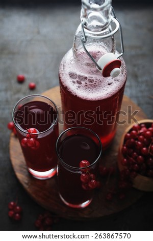 Red lemonade with berries on a vintage wooden table