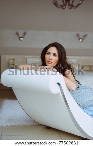beautiful woman sitting in a chair and relaxation in the house