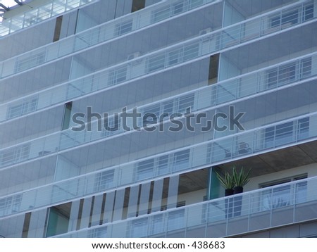 Modern building with plants on balcony