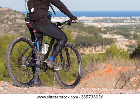 Mountain Bike cyclist takes a break enjoying view
