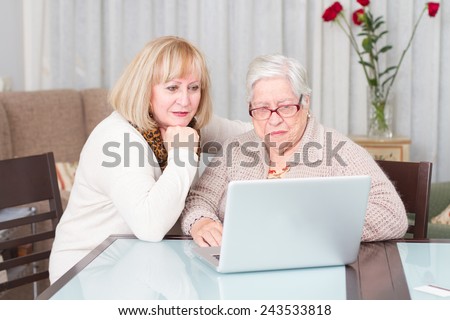 Learning Internet. Grandmother and daughter using computer at home