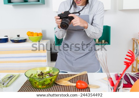 Food Blogger. Portrait of young man shooting food in kitchen