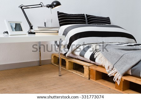 Recycled diy pallet platform bed in modern bedroom
