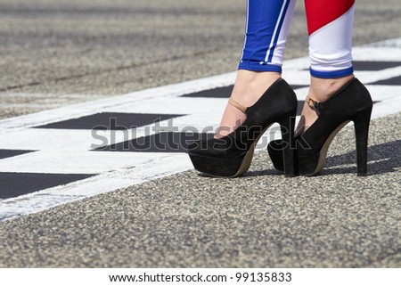 High heel in the start line and pole position on a Grand Prix circuit/High heel in the start line