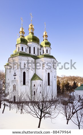 Saint George cathedral in snow at Vydubetsky monastery in Kiev on sunny day in winter