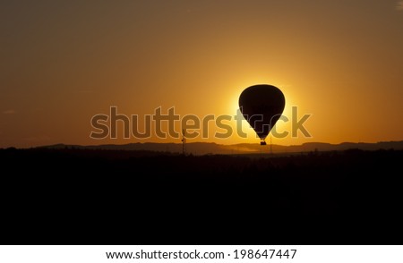 hot air ballooning silhouettes in the sunset