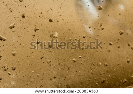 Motocross race - dust and pieces of soil in the dust cloud captured right after the racer started off