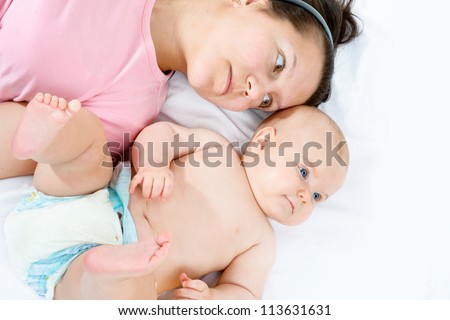 Mother and baby closeup portrait, happy faces, Caucasian family picture, adorable small girl, mom and kid having fun indoor, parents joy, holding little child, healthy toddler and mommy