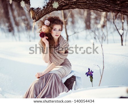 Fashion shoot of young beautiful girl in the winter forest